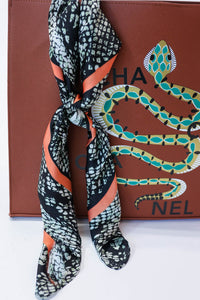 Wrapped In Smiles Snake Print Scarf In Rust